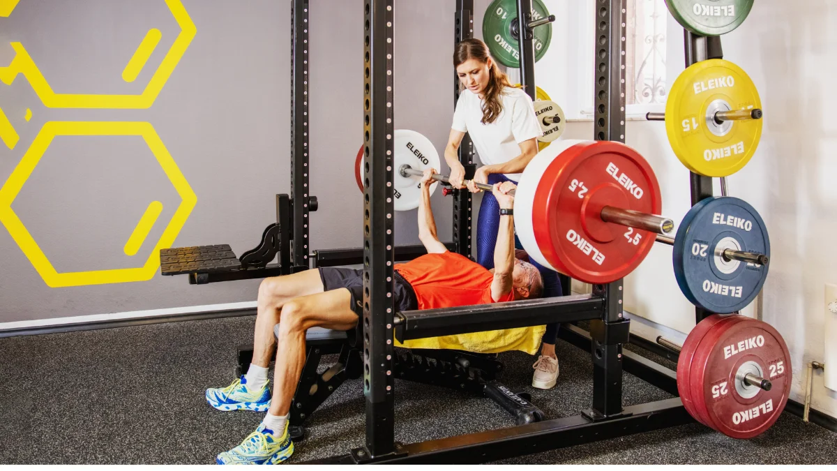 Trainerin Julia Striffler sichert einen Kunden beim Bankdrücken im Fitlab Stuttgart